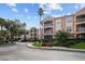 Beautiful condo building with manicured landscaping, sidewalks, and a tropical feel at 5000 Culbreath Key Way # 1-112, Tampa, FL 33611