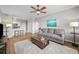 Open living room featuring wood floors, ceiling fan and access to kitchen at 5000 Culbreath Key Way # 1-112, Tampa, FL 33611