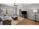 Bright living room with hardwood floors, white plantation shutters, and ceiling fan at 5000 Culbreath Key Way # 1-112, Tampa, FL 33611