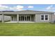 Expansive backyard features a covered patio perfect for relaxing or entertaining at 5178 Everlong Dr, Apollo Beach, FL 33572