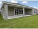 Large backyard features a covered patio with open space for outdoor activities at 5178 Everlong Dr, Apollo Beach, FL 33572