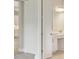 Bathroom with light wood door and bright white cabinets and chrome hardware at 5178 Everlong Dr, Apollo Beach, FL 33572