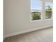 Empty bedroom featuring neutral carpet and two windows with a view outside at 5178 Everlong Dr, Apollo Beach, FL 33572