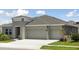 Charming home features a spacious three-car garage and well-manicured landscaping at 5178 Everlong Dr, Apollo Beach, FL 33572