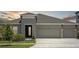 Beautiful home featuring a two-car garage, stylish accents, and lush landscaping at 5178 Everlong Dr, Apollo Beach, FL 33572