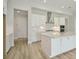 Bright, modern kitchen featuring white cabinets, stainless steel appliances, and a large center island at 5178 Everlong Dr, Apollo Beach, FL 33572