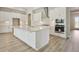 Spacious kitchen with large island, white cabinets, stainless steel appliances, and modern lighting at 5178 Everlong Dr, Apollo Beach, FL 33572