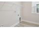 This convenient laundry room is equipped with overhead shelving and modern hookups at 5178 Everlong Dr, Apollo Beach, FL 33572
