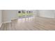 Spacious living room with sleek wood floors and sliding glass doors leading to the backyard at 5178 Everlong Dr, Apollo Beach, FL 33572