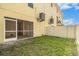 Small fenced backyard area with a screened-in patio, blending indoor-outdoor living at 5521 Yellowfin Ct, New Port Richey, FL 34652