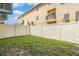 Backyard featuring a white fence and a small patch of grass at 5521 Yellowfin Ct, New Port Richey, FL 34652