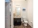 Cozy half bath with a dark vanity, wood-look flooring, and colorful fish art at 5521 Yellowfin Ct, New Port Richey, FL 34652