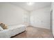 Neutral carpeted bedroom with a small bed, light walls, and two white doors at 5521 Yellowfin Ct, New Port Richey, FL 34652
