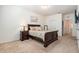 Bedroom with large bed, nightstand, painting, and doorway at 5521 Yellowfin Ct, New Port Richey, FL 34652