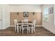 Cozy dining room features wood floors, modern furniture, and natural light from a window at 5521 Yellowfin Ct, New Port Richey, FL 34652