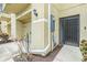 Side view of the entrance, featuring a private garage and an exterior door with security bars at 5521 Yellowfin Ct, New Port Richey, FL 34652