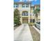 Attractive townhouse featuring a private balcony, attached garage, and manicured landscaping at 5521 Yellowfin Ct, New Port Richey, FL 34652