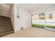Spacious garage with stairs leading up, and a door leading to the backyard at 5521 Yellowfin Ct, New Port Richey, FL 34652