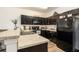Modern kitchen features granite countertops, dark cabinets, and stainless steel appliances at 5521 Yellowfin Ct, New Port Richey, FL 34652