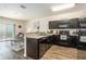 Modern kitchen features dark cabinets, granite countertops, and stainless steel appliances at 5521 Yellowfin Ct, New Port Richey, FL 34652