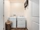 Functional laundry room with white washer and dryer and wood look flooring at 5521 Yellowfin Ct, New Port Richey, FL 34652