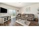 Inviting living room with wood floors, modern furnishings, and a sliding glass door at 5521 Yellowfin Ct, New Port Richey, FL 34652