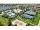 Aerial view showcasing a community pool, tennis courts, basketball court, and volleyball court at 5611 Del Coronado Dr, Apollo Beach, FL 33572