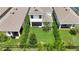 Aerial view of backyard with a grassy lawn, trees, fence, patio, and neighboring homes at 5611 Del Coronado Dr, Apollo Beach, FL 33572