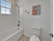 Clean bathroom featuring a shower and tub combination, a toilet, and nautical-themed decorations at 5611 Del Coronado Dr, Apollo Beach, FL 33572
