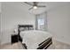 Neutral bedroom with a ceiling fan, one window, a bed with patterned pillows and a bedside table at 5611 Del Coronado Dr, Apollo Beach, FL 33572