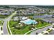Aerial view of an aquatic center featuring a pool, a splash pad, and many lounge chairs at 5611 Del Coronado Dr, Apollo Beach, FL 33572