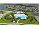 Aerial view of a large community pool, amenity center, playground, and landscaping at 5611 Del Coronado Dr, Apollo Beach, FL 33572