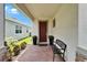 Charming entryway featuring a brick paver floor, bench, and decorative potted plants at 5611 Del Coronado Dr, Apollo Beach, FL 33572