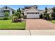 Inviting home with a brick paver driveway and lush landscaping, perfect for curb appeal at 5611 Del Coronado Dr, Apollo Beach, FL 33572