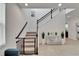 Bright foyer featuring tiled floors, staircase, and an elegant console table with plants at 5611 Del Coronado Dr, Apollo Beach, FL 33572