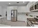Stylish kitchen with stainless steel appliances and white cabinets at 5611 Del Coronado Dr, Apollo Beach, FL 33572