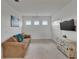 Cozy living room with a comfortable sofa, entertainment center, and bright natural light at 5611 Del Coronado Dr, Apollo Beach, FL 33572