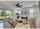 Living room with large couch and sliding doors to outdoor living space at 5611 Del Coronado Dr, Apollo Beach, FL 33572