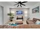 Bright living room with a large ceiling fan, tiled floors, and large TV at 5611 Del Coronado Dr, Apollo Beach, FL 33572