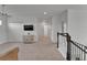 Open loft area with neutral carpet, TV and stylish console, offering a versatile living space at 5611 Del Coronado Dr, Apollo Beach, FL 33572