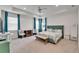 Open main bedroom with an ample sitting area, a ceiling fan and three windows at 5611 Del Coronado Dr, Apollo Beach, FL 33572