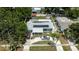 Aerial view of the house showcases the solar panels, fenced in yard and mature trees at 5895 16Th N St, St Petersburg, FL 33703