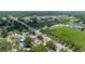 Expansive aerial view of a neighborhood with lush greenery and proximity to a school with sports facilities at 5895 16Th N St, St Petersburg, FL 33703