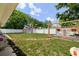 Backyard featuring a shed, a brick oven, and lush green grass at 5895 16Th N St, St Petersburg, FL 33703