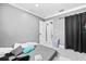 Bedroom with neutral walls, tile floors, and a door to a hallway at 5895 16Th N St, St Petersburg, FL 33703