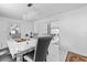 Dining room with a modern chandelier, large marble table, and stylish tile flooring at 5895 16Th N St, St Petersburg, FL 33703