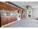 Kitchen featuring dark wood cabinets, white appliances, and granite countertops at 5895 16Th N St, St Petersburg, FL 33703