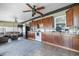 Kitchen with dark wood cabinets, white appliances, and a ceiling fan at 5895 16Th N St, St Petersburg, FL 33703