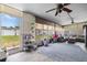 Sunroom with tile floors, ceiling fan, large windows, and an exterior door at 5895 16Th N St, St Petersburg, FL 33703