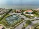 Community aerial view featuring tennis courts, pool, playground, well maintained streets, and waterfront at 6107 Marbella Blvd, Apollo Beach, FL 33572